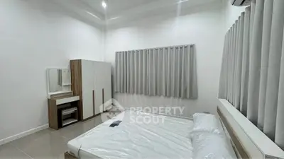 Modern minimalist bedroom with sleek furniture and neutral tones