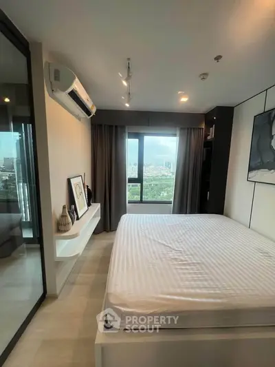 Modern bedroom with large window offering stunning city view, featuring minimalist decor and air conditioning.