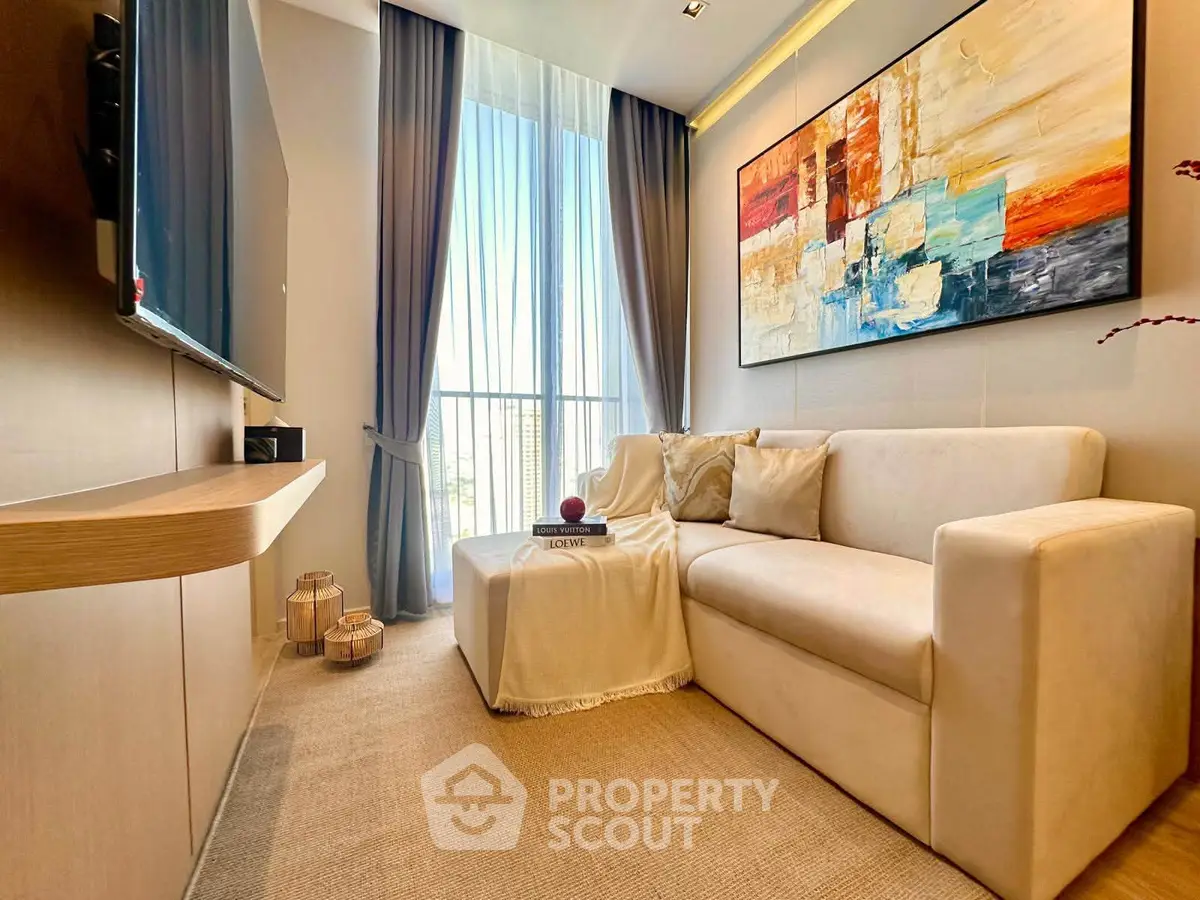 Modern living room with elegant decor and large window, featuring a cozy sofa and stylish artwork.
