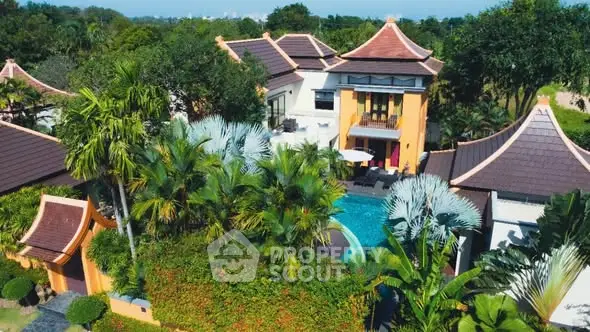 Luxurious tropical villa with pool and lush garden, showcasing exquisite architecture and serene surroundings.