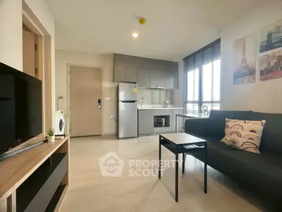 Modern living room with sleek kitchen, stylish decor, and ample natural light.
