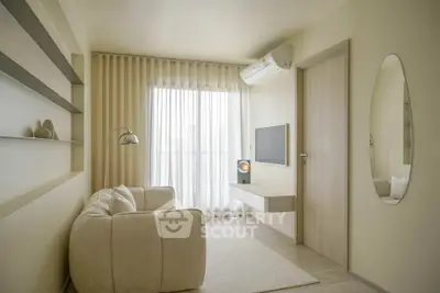 Modern minimalist living room with cozy sofa, wall-mounted TV, and elegant decor.
