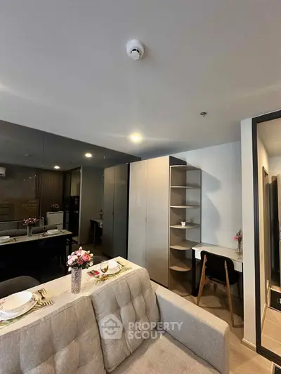 Modern living room with stylish furniture and dining setup in a cozy apartment.