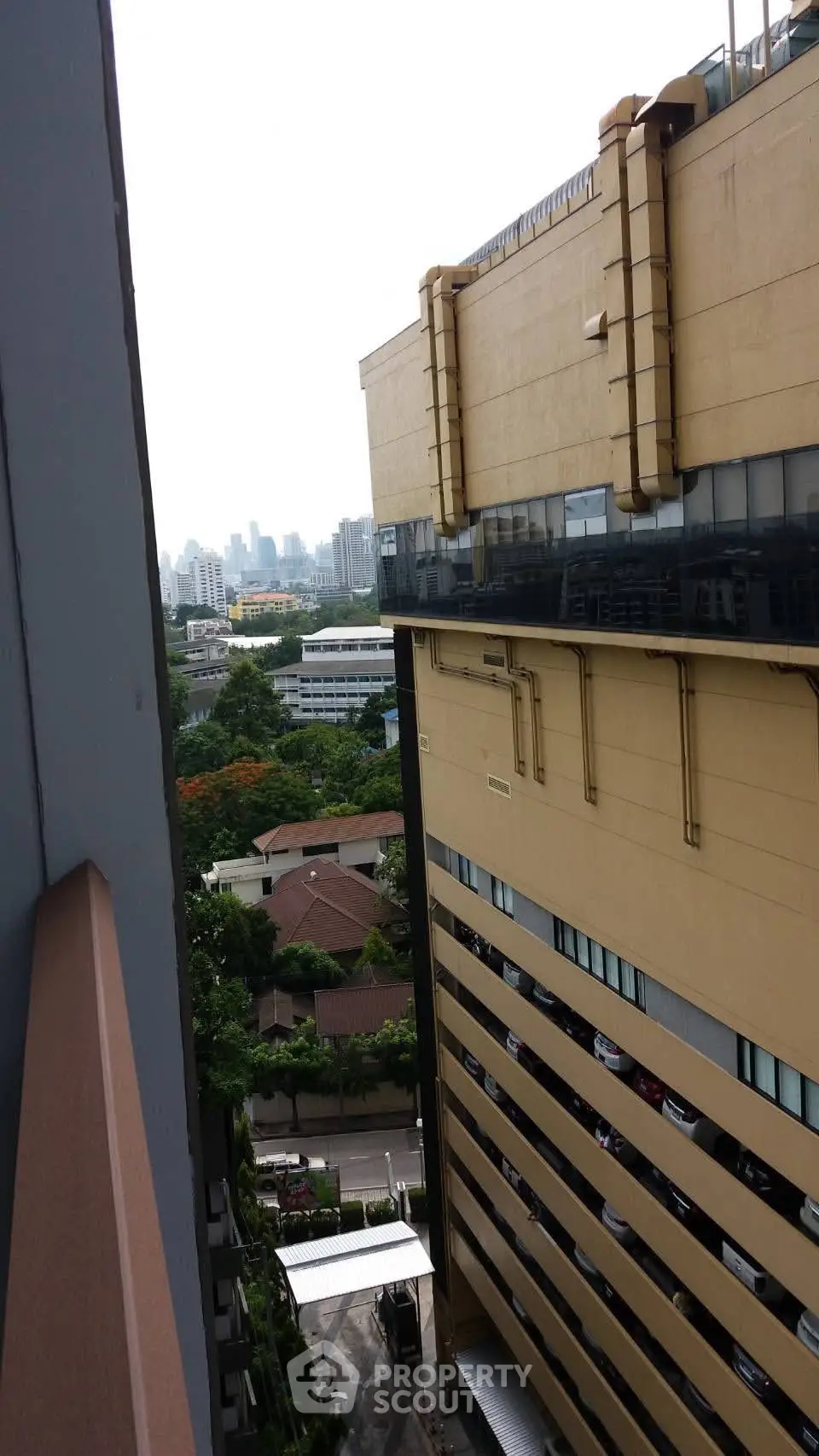 Urban building view with cityscape and greenery, showcasing modern architecture and skyline.