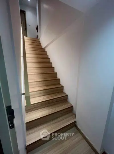 Modern wooden staircase in a sleek minimalist home interior