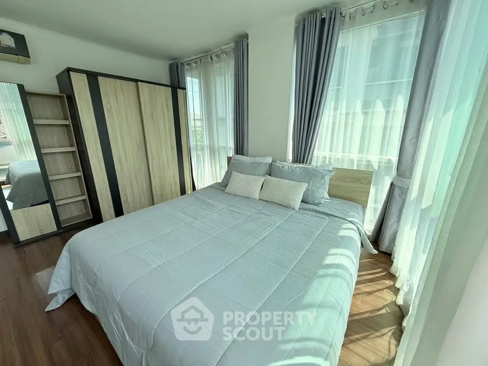 Bright and airy bedroom with modern decor and large windows