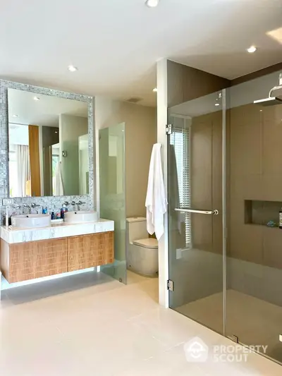 Luxurious modern bathroom with glass shower and elegant vanity