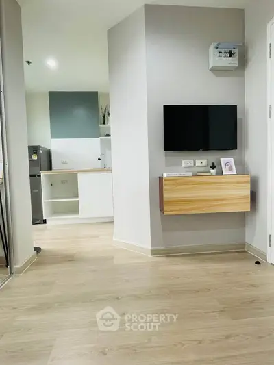 Modern apartment interior with sleek kitchen and wooden flooring