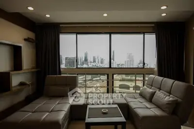 Spacious living room with city view and modern furniture.