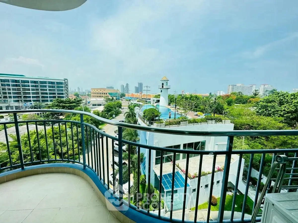 Stunning balcony view overlooking cityscape with lush greenery and modern architecture.