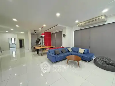 Spacious modern living room with sleek furniture and open layout, perfect for entertaining.