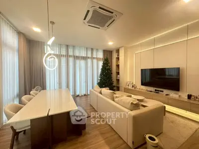 Elegant living room with modern decor, large windows, and stylish lighting