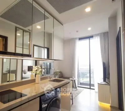 Modern open-layout kitchen with sleek appliances and bright living area