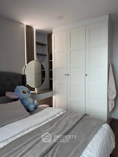 Cozy bedroom with modern wardrobe and plush decor