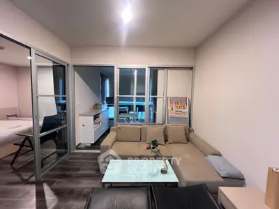 Modern living room with cozy beige sofa and glass coffee table in stylish apartment.