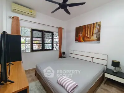 Cozy bedroom with modern decor and large window for natural light