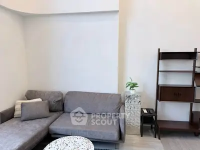 Modern living room with stylish gray sofa and elegant shelving unit