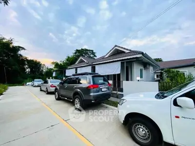 Charming suburban house with driveway and parked cars, perfect for family living.