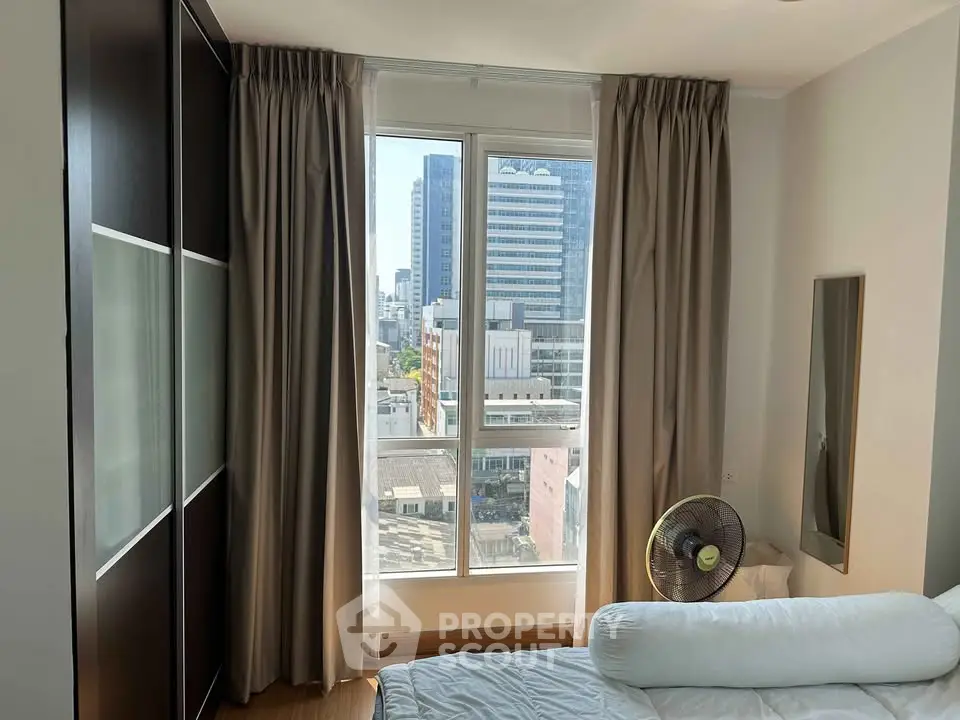 Bright bedroom with city view and modern furnishings