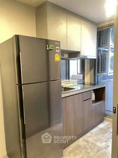 Modern kitchen with sleek fridge and ample storage space