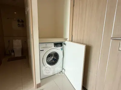 Compact bathroom with integrated washing machine in modern apartment