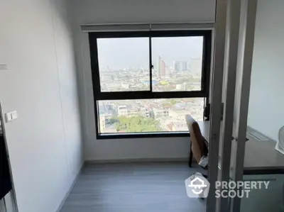 Modern study room with city view from high-rise apartment window