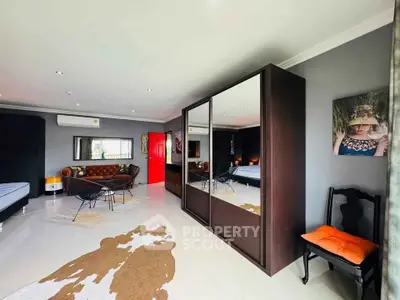 Spacious modern living room with stylish decor and large mirrored wardrobe