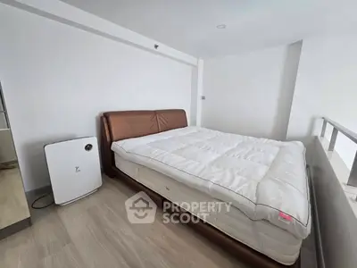 Modern bedroom with sleek design and air purifier for a comfortable living space.