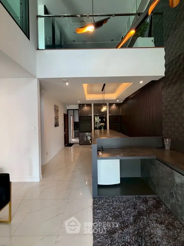 Modern interior with open layout, stylish decor, and mezzanine level in luxury home.