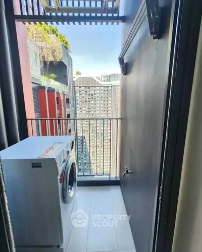 Compact balcony with washing machine and city view in modern apartment