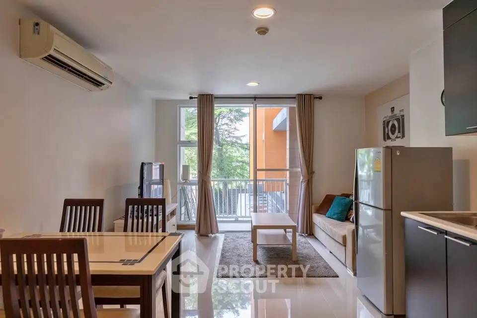 Modern living room with open kitchen and balcony view in a stylish apartment.