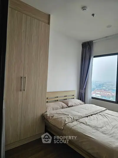 Cozy bedroom with city view and wooden wardrobe
