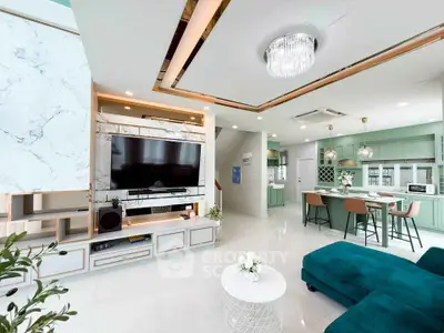 Luxurious open-plan living room with modern kitchen and elegant decor.