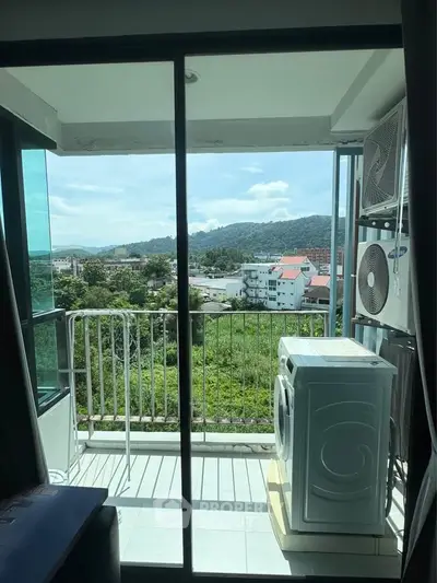 Stunning balcony view with lush greenery and cityscape, featuring modern air conditioning unit.