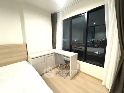 Modern bedroom with study area and city view