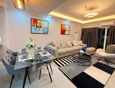 Luxurious modern living room with stylish decor and elegant dining area, perfect for entertaining.