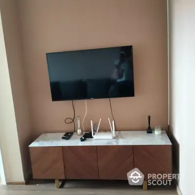 Modern living room with wall-mounted TV and stylish wooden cabinet