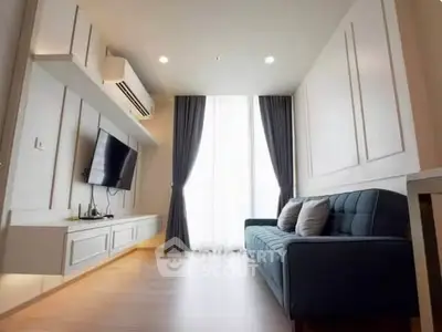 Modern living room with sleek design, featuring a wall-mounted TV and stylish sofa, perfect for relaxation.
