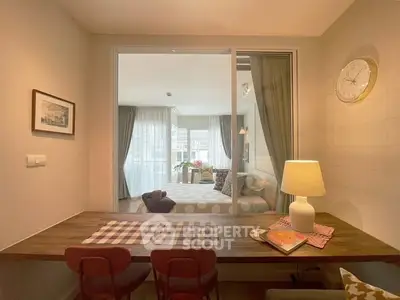 Modern living room with elegant decor and large windows offering natural light.