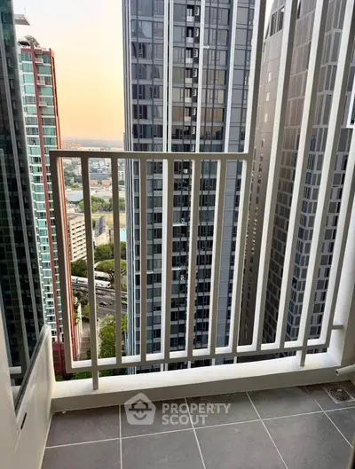 Modern high-rise balcony with stunning cityscape view, perfect for urban living enthusiasts.