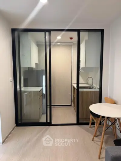 Modern kitchen with sleek glass sliding doors and compact design