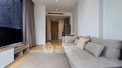 Modern living room with cozy sofa and stylish decor in a contemporary apartment.