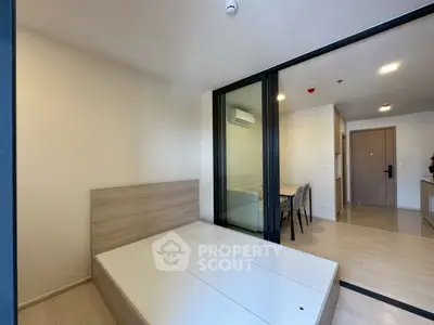 Modern bedroom with sliding glass doors and minimalist design