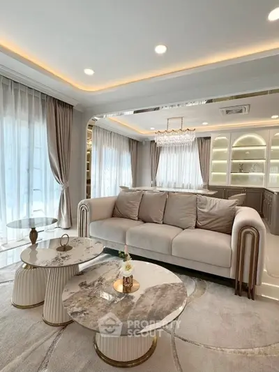 Luxurious living room with elegant sofa, marble tables, and ambient lighting in a modern apartment.