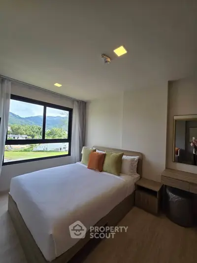 Modern bedroom with scenic mountain view and stylish decor