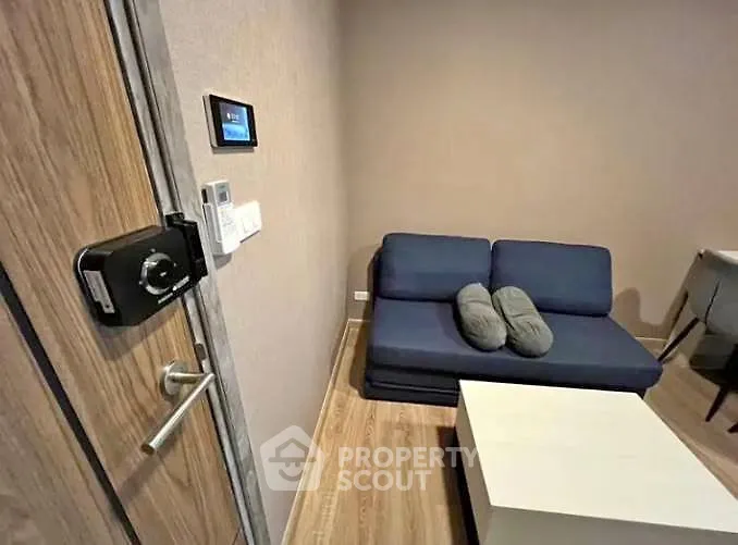 Cozy living room with modern sofa and smart lock entry, perfect for urban living.