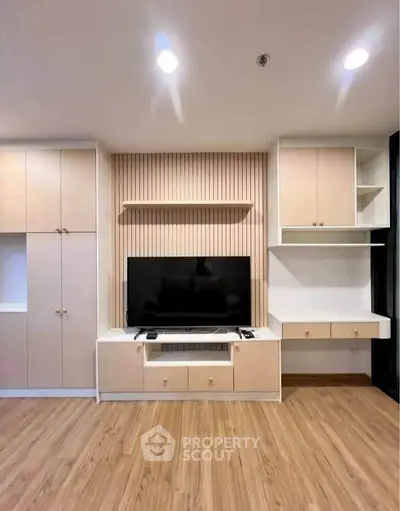 Modern living room with built-in TV cabinet and wooden flooring
