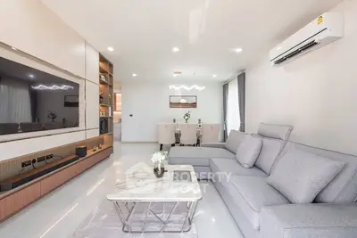 Spacious modern living room with elegant decor and open dining area
