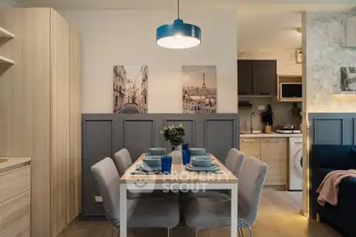 Stylish dining area with modern decor and cozy ambiance in a contemporary apartment.