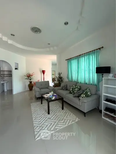 Spacious living room with modern decor and natural light